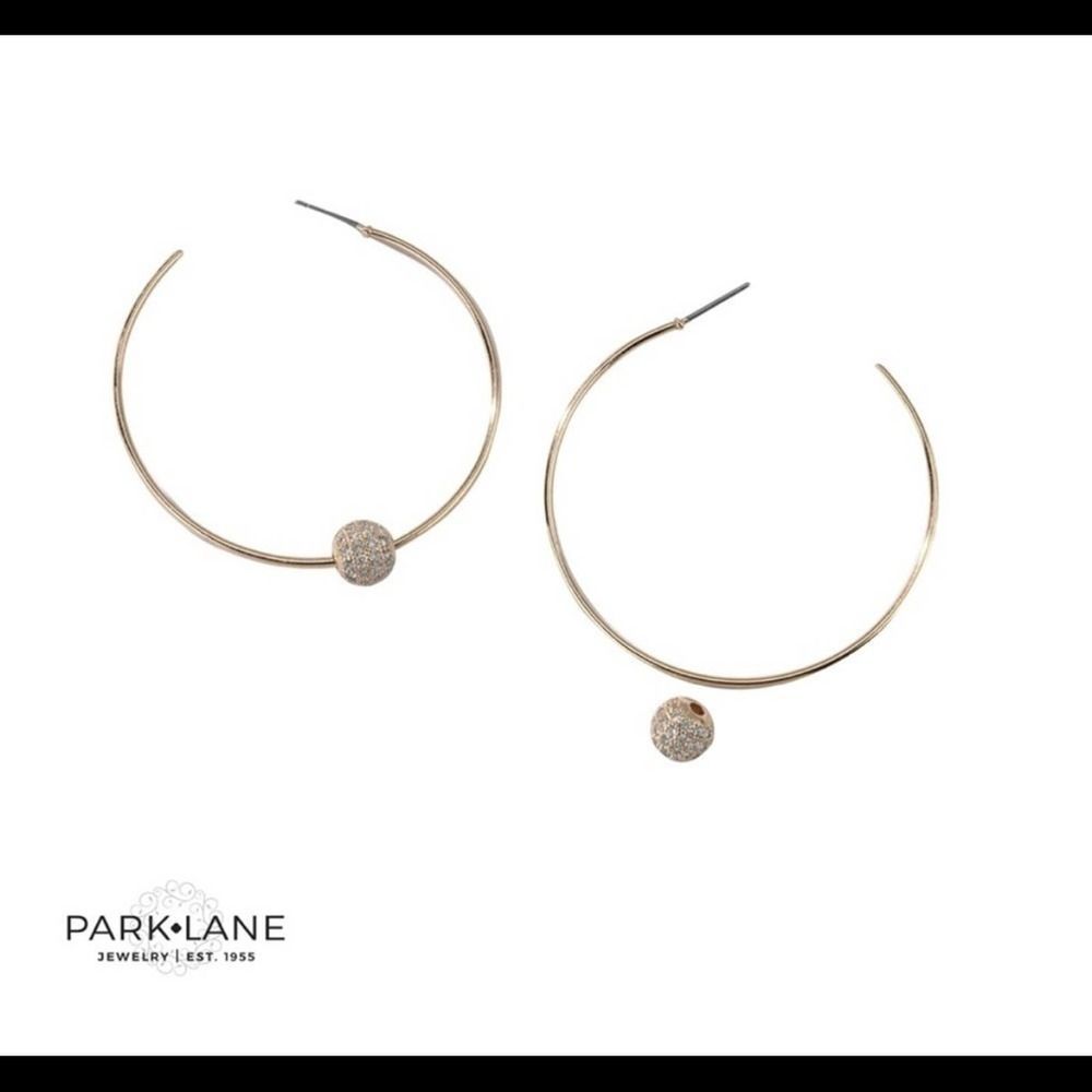 The Carrington Earrings are delicate golden hoops with a CZ sphere accent